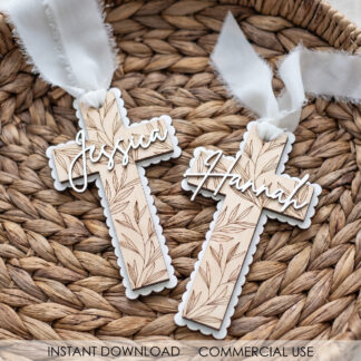 Personalized name cross SVG laser cut from wood with floral engraving and custom name, styled in a rustic basket with linen ribbon.