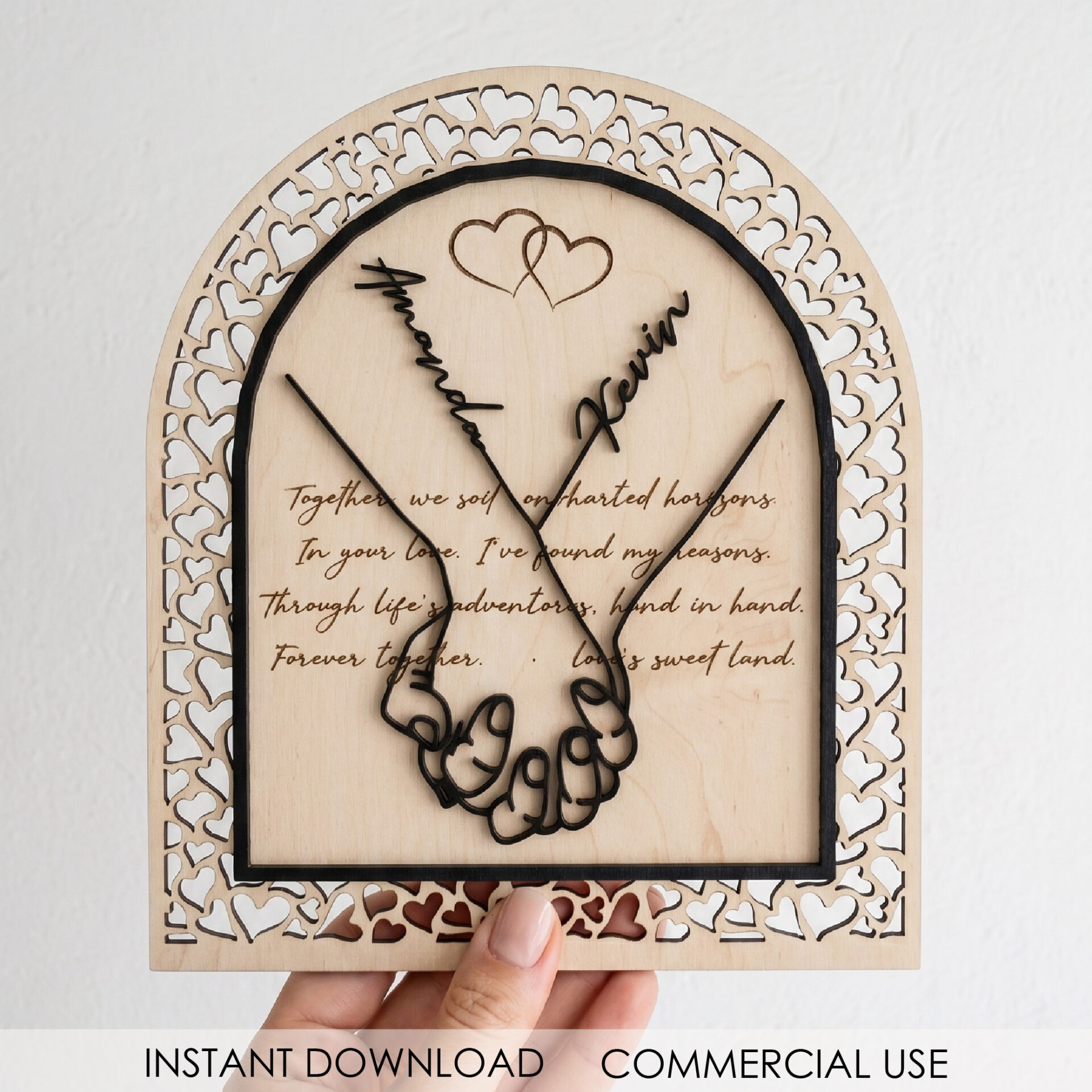 Personalized Couple Sign SVG arched laser cut design with hand heart detail and custom names displayed on a stand for anniversary decor