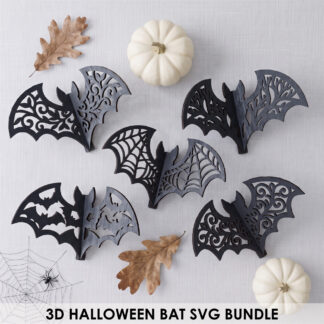 3d bat svg bundle of five layered filigree Halloween bats cut from wood, styled as hanging ornaments with pumpkins and dried florals.