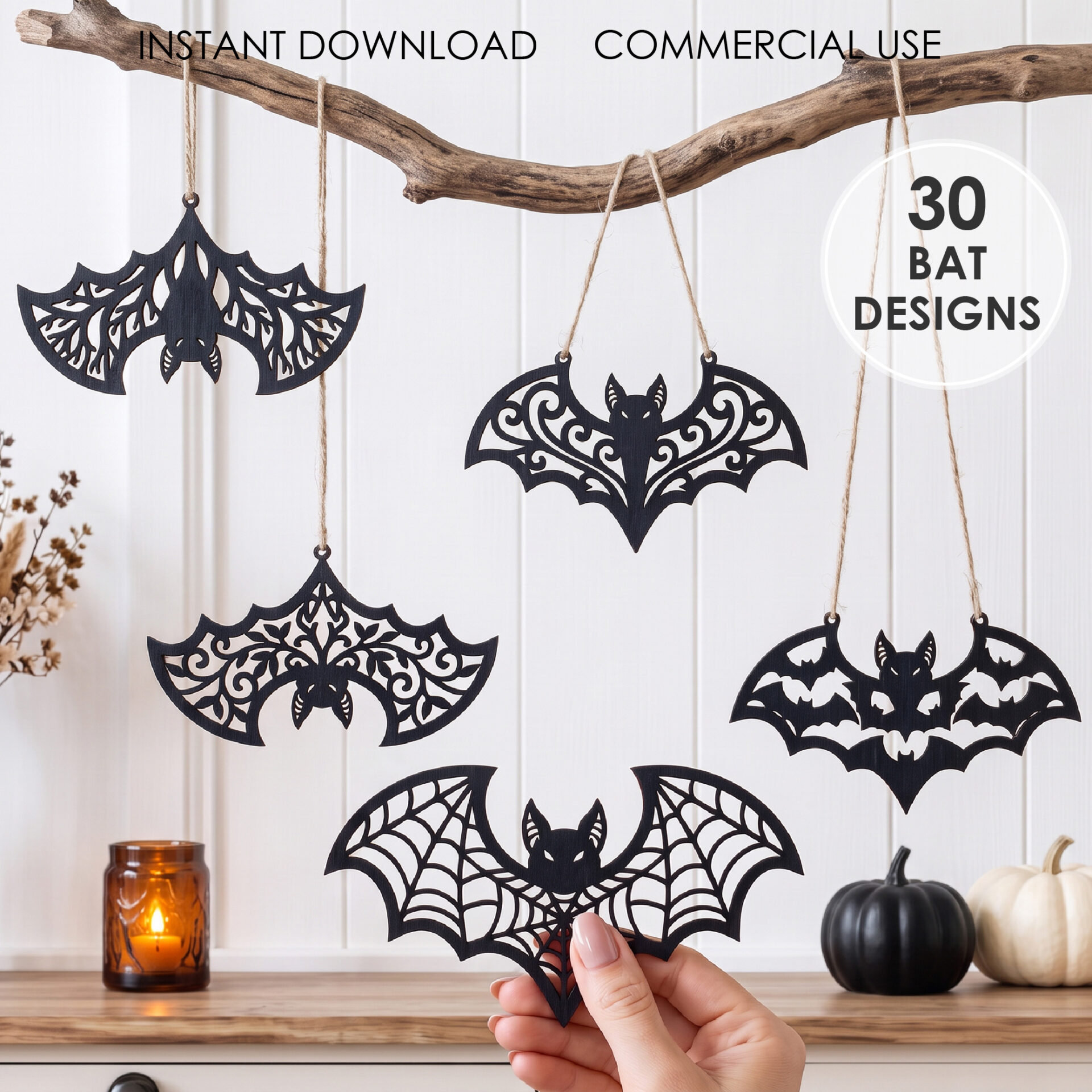 Halloween bat SVG designs cut from black wood, filigree bat ornaments hanging on a branch as spooky home decor